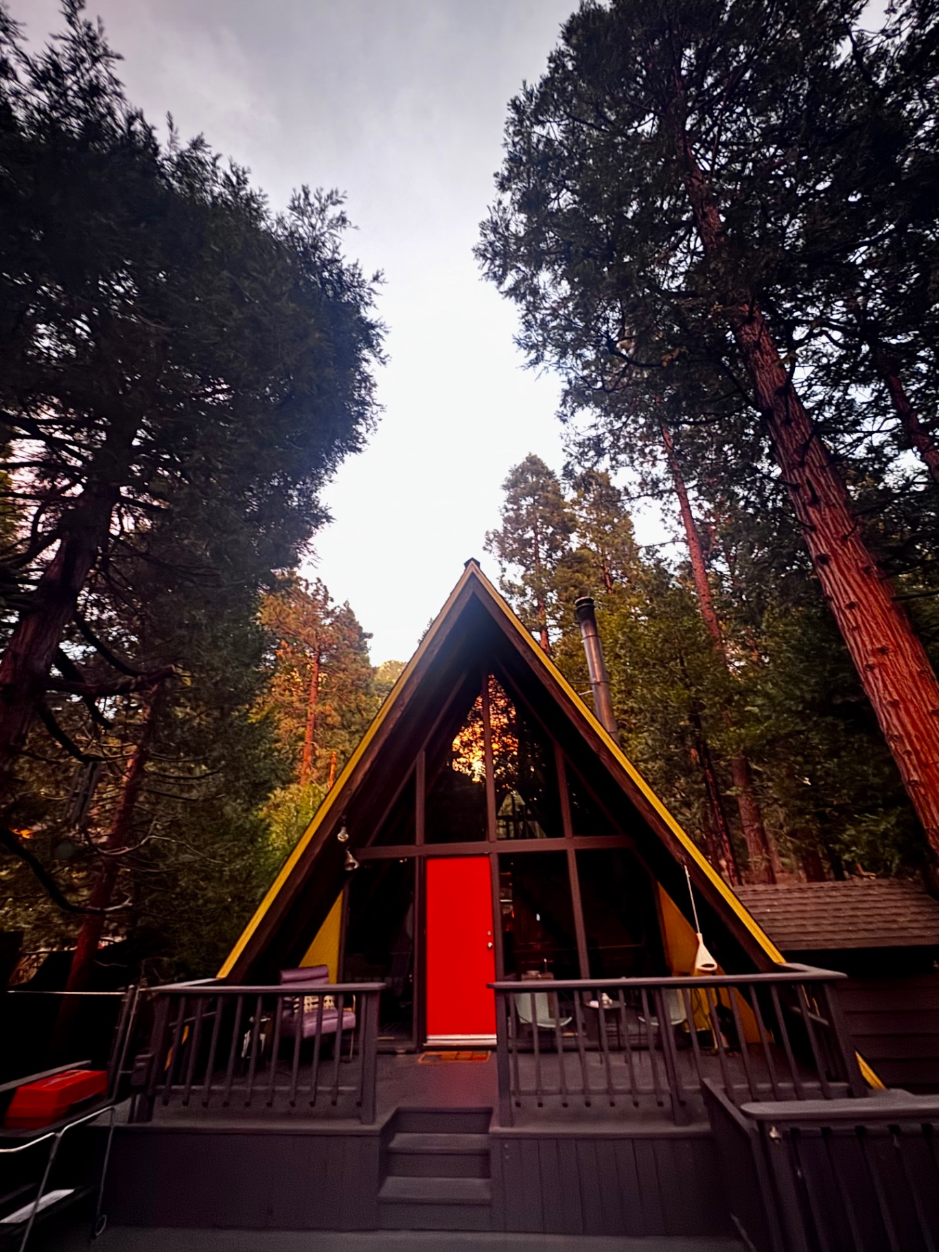 The red front door and yellow trim at dusk