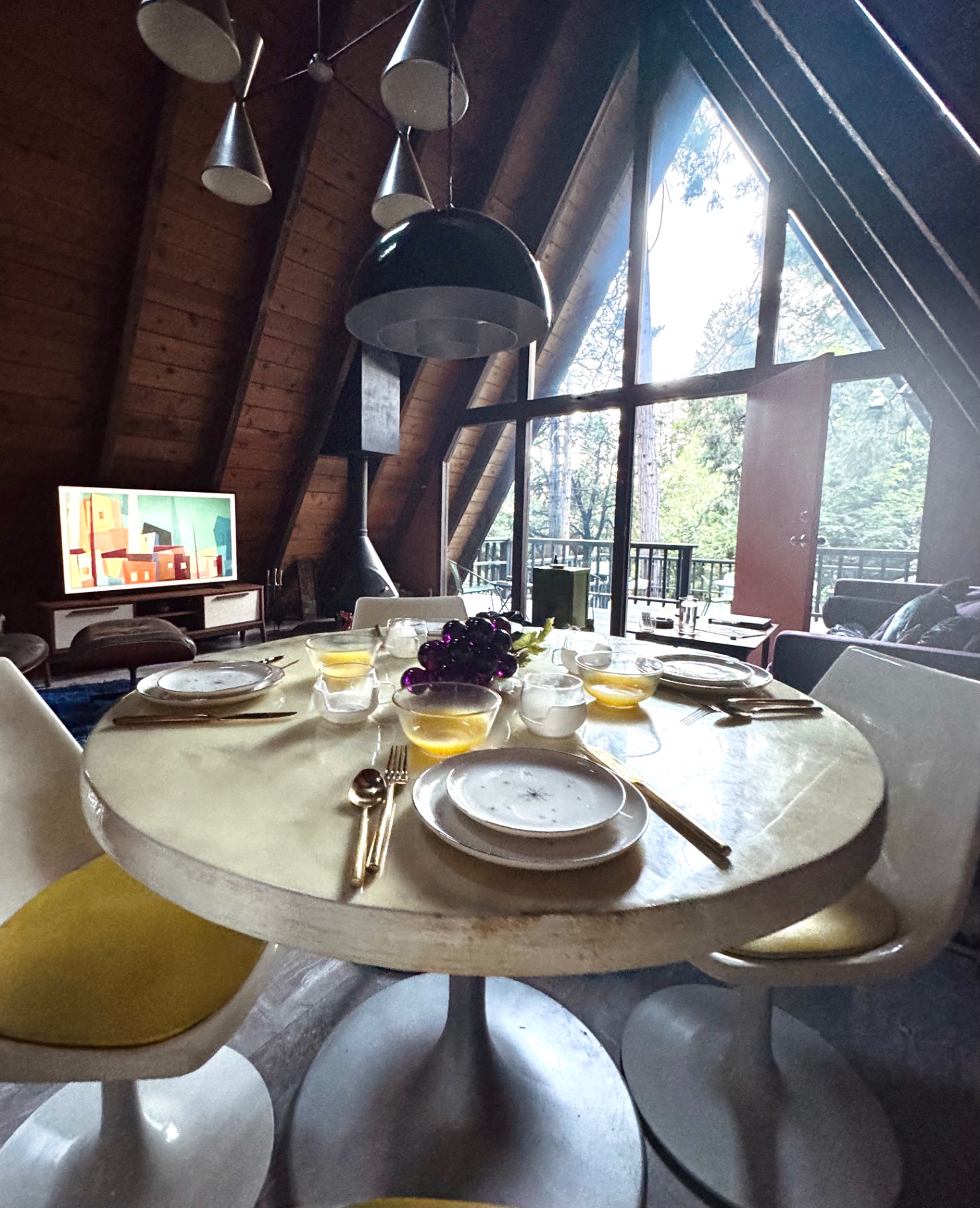 Tulip dining table under mid-century chandelier